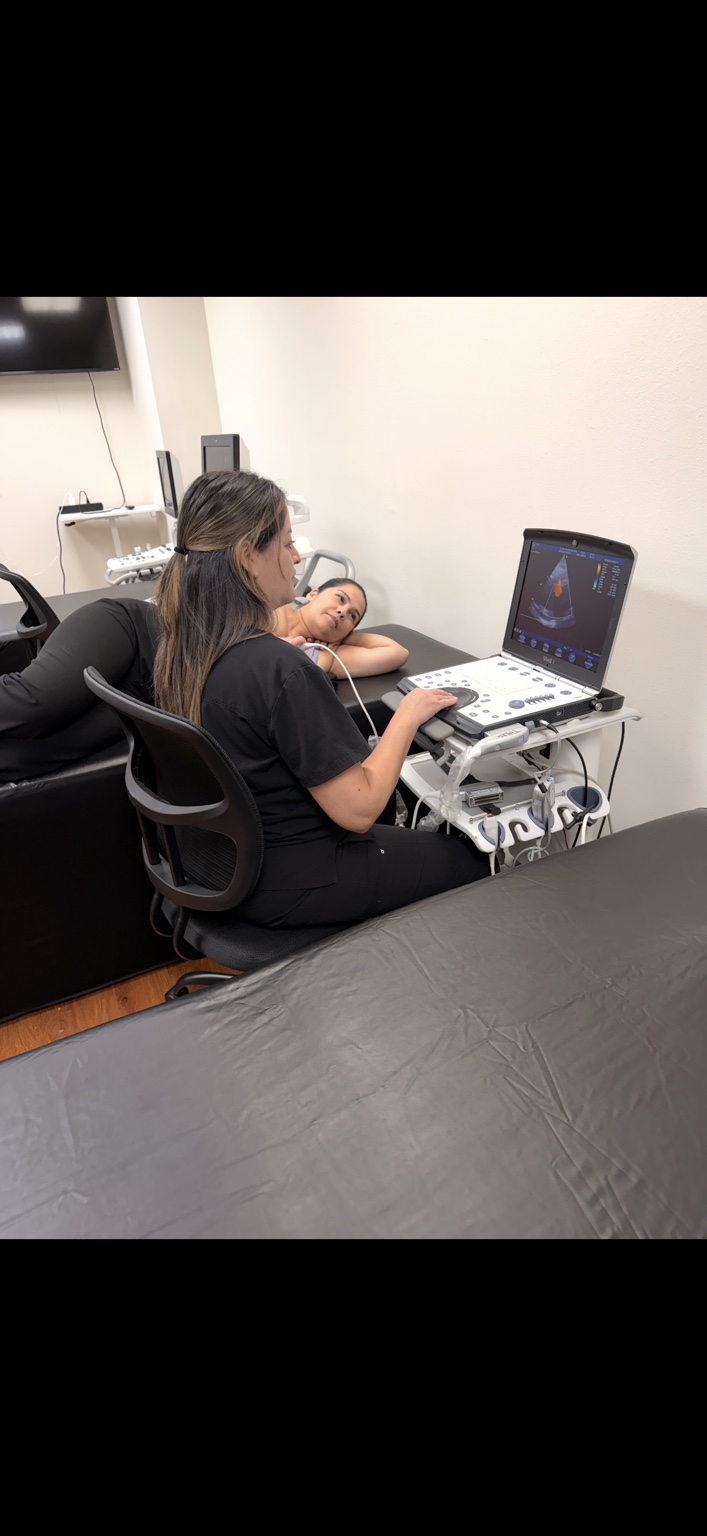 Hands-on echocardiography practice at SC Healthcare College with a student operating an ultrasound machine